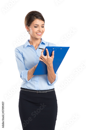 Photo: Smiling Businesswoman Writing On Clipboard Smiling Businesswoman Writing On Clipboard