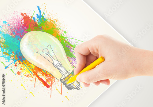 Photo: Hand drawing on paper a colorful splatter lightbulb Hand drawing on paper a colorful splatter lightbulb