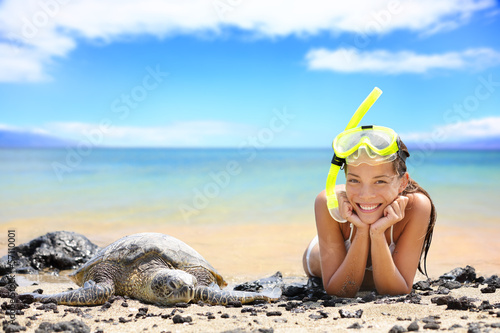 Photo: Beach travel woman on Hawaii with sea sea turtle Beach travel woman on Hawaii with sea sea turtle