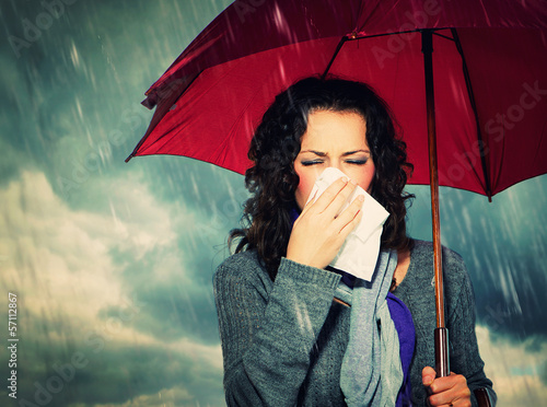 Photo: Sneezing Woman with Umbrella over Autumn Rain Background Sneezing Woman with Umbrella over Autumn Rain Background