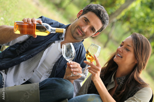 Photo: couple with drinks in the countryside couple with drinks in the countryside