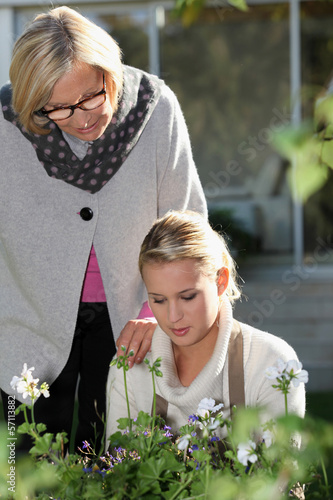 Photo: Older and younger women in a garden Older and younger women in a garden