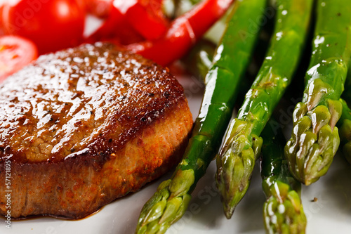 Photo: Grilled steaks and asparagus Grilled steaks and asparagus