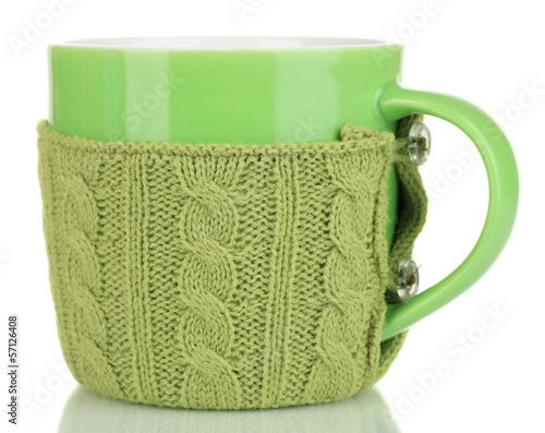 Photo: Cup with knitted thing on it isolated on white Cup with knitted thing on it isolated on white