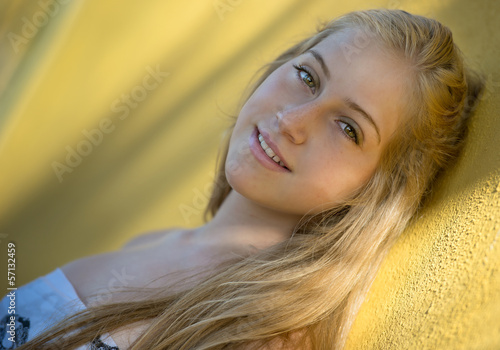 Photo: Close-up of a young woman smiling on the bea Close-up of a young woman smiling on the bea