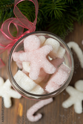 Photo: Multi-colored sugar in the form of little people in a glass jar Multi-colored sugar in the form of little people in a glass jar
