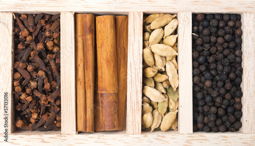 Photo: Wooden box with different kinds of spices, close-up, top view Wooden box with different kinds of spices, close-up, top view