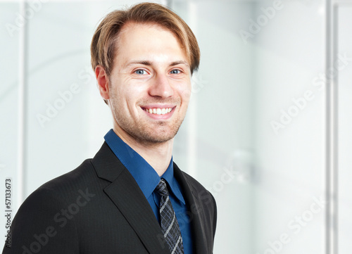 Photo: Smiling businessman in the office Smiling businessman in the office