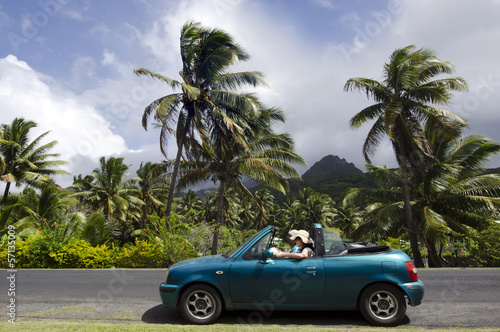 Photo: Couple traveling by convertible car in a Pacific Island Couple traveling by convertible car in a Pacific Island
