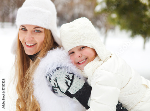 Photo: Young blond mother with daughter having fun outdoors Young blond mother with daughter having fun outdoors