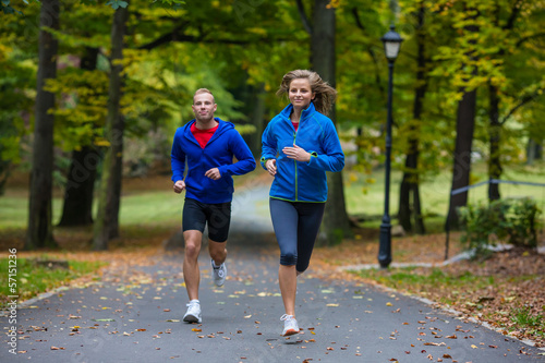 Photo: Urban leisure - woman and man running in park Urban leisure - woman and man running in park