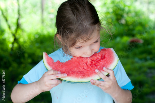 Photo: girl eating fresh watermelon girl eating fresh watermelon
