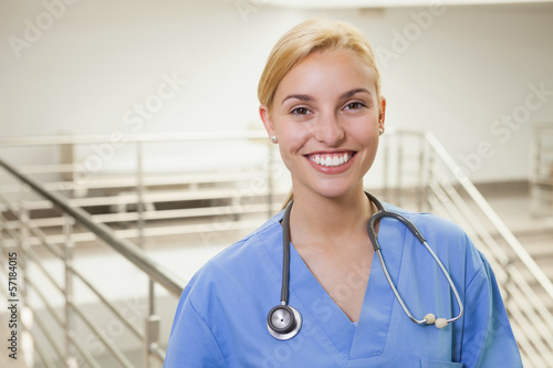Photo: Nurse in a stairwell smiling Nurse in a stairwell smiling