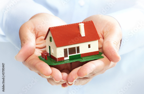 Photo: Hands with little house. Hands with little house.
