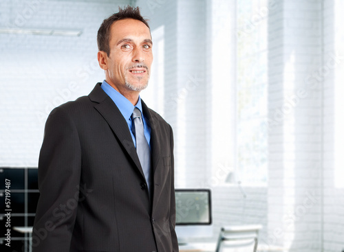 Photo: Smiling businessman in the office Smiling businessman in the office
