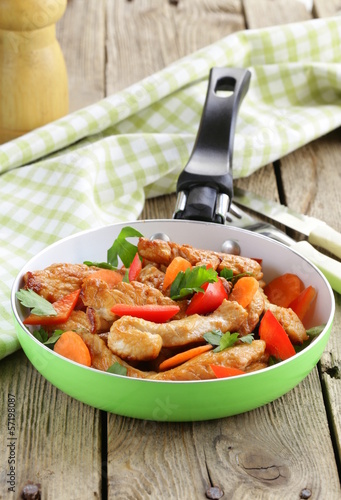Photo: fried chicken (turkey) fillets with vegetables in a pan fried chicken (turkey) fillets with vegetables in a pan