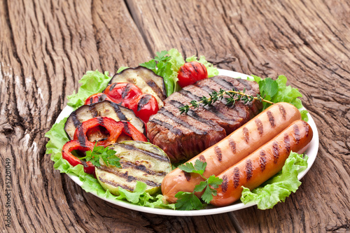 Photo: Grilled steak,sausages and vegetables. Grilled steak,sausages and vegetables.