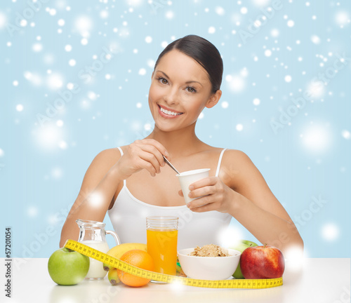Photo: woman with healthy breakfast and measuring tape woman with healthy breakfast and measuring tape