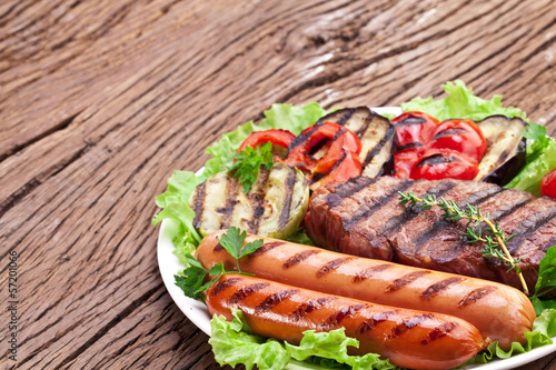 Photo: Grilled steak,sausages and vegetables. Grilled steak,sausages and vegetables.