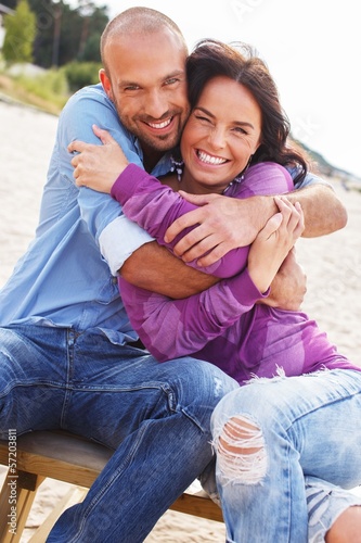 Photo: Happy smiling middle-aged couple on a beach Happy smiling middle-aged couple on a beach
