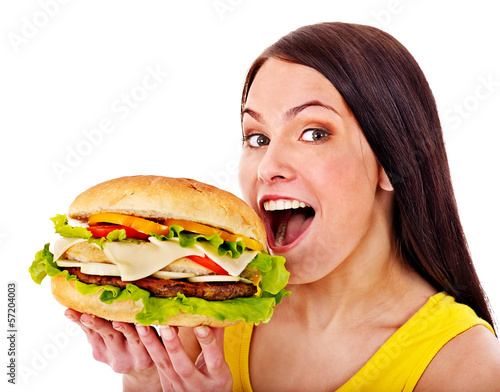 Photo: Woman holding hamburger. Woman holding hamburger.