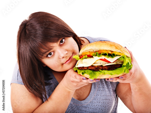 Photo: Woman eating hamburger. Woman eating hamburger.