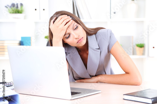 Photo: Young business woman in office Young business woman in office