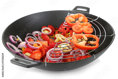 Photo: Vegetables in wok isolated on white Vegetables in wok isolated on white