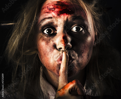 Photo: Scary zombie horror face gesturing silence Scary zombie horror face gesturing silence