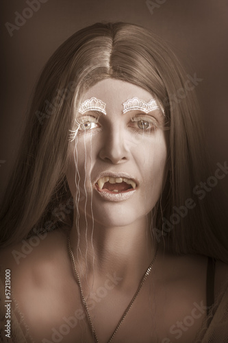 Photo: Vintage halloween portrait. Gothic vampire girl Vintage halloween portrait. Gothic vampire girl