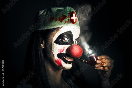 Photo: Fine art horror portrait. Smoking surgeon clown Fine art horror portrait. Smoking surgeon clown