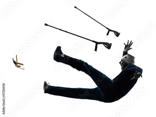 Photo: injured man with crutches slipping silhouette injured man with crutches slipping silhouette