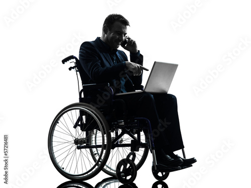 Photo: handicapped business man computing laptop computer in wheelchai handicapped business man computing laptop computer in wheelchai