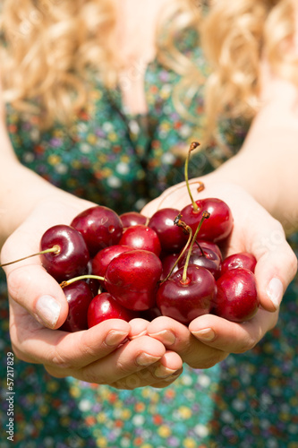 Photo: Close up of a blonde woman showing some cherries Close up of a blonde woman showing some cherries