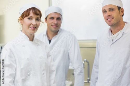 Photo: Three bakers posing in a kitchen Three bakers posing in a kitchen
