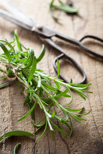 Photo: fresh rosemary herb on wooden background fresh rosemary herb on wooden background