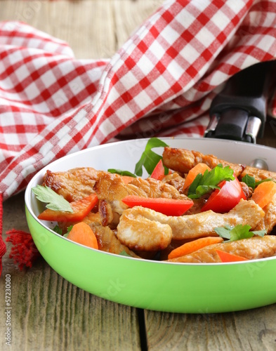 Photo: fried chicken (turkey) fillets with vegetables in a pan fried chicken (turkey) fillets with vegetables in a pan