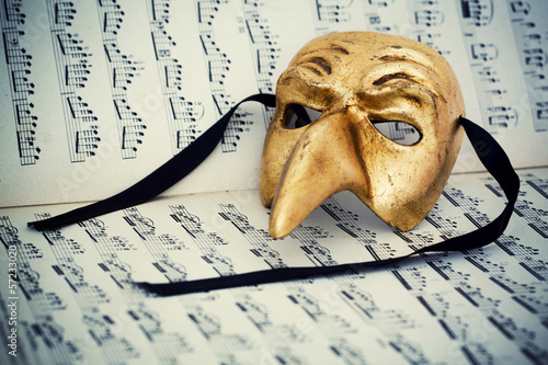 Photo: Venice mask on musical score Venice mask on musical score