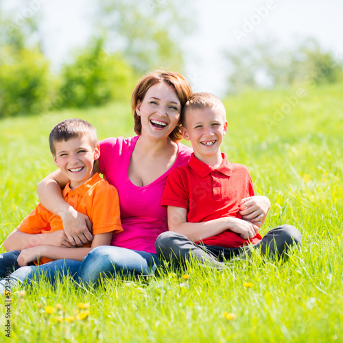 Photo: Young happy mother with children in park Young happy mother with children in park