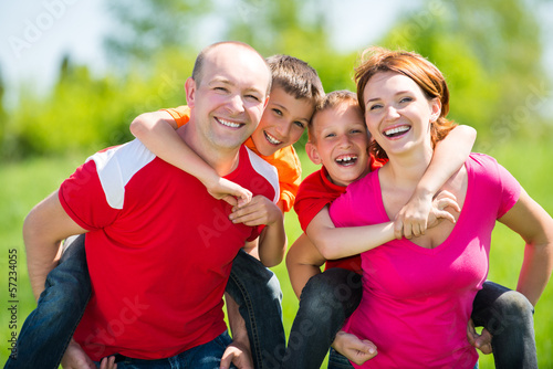 Photo: Happy family with two children on nature Happy family with two children on nature