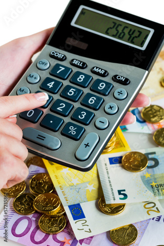 Photo: Hand mit Taschenrechner und Geld Hand mit Taschenrechner und Geld