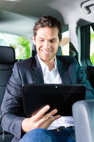 Photo: Man traveling in taxi, he has an appointment Man traveling in taxi, he has an appointment