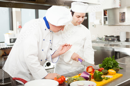 Photo: Chief chef watching his assistant Chief chef watching his assistant