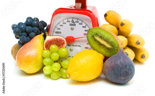 Photo: fresh juicy fruits and red scales. white background. fresh juicy fruits and red scales. white background.
