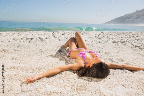 Photo: Attractive young woman in pink bikini sunbathing Attractive young woman in pink bikini sunbathing
