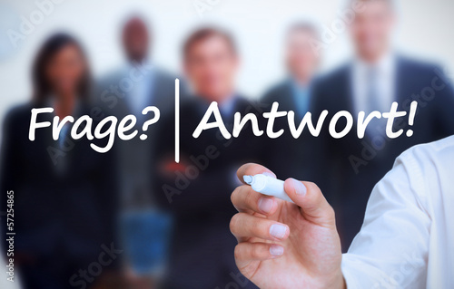 Photo: Buisnessman writing frage and antwort with a marker Buisnessman writing frage and antwort with a marker