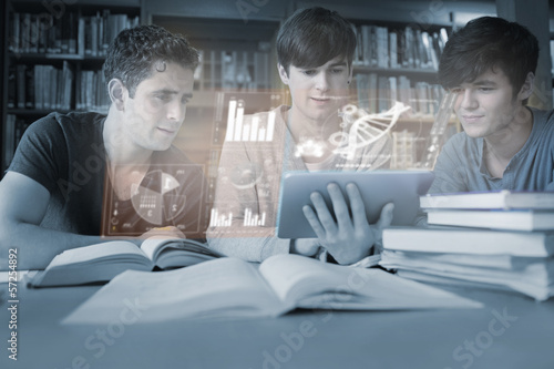 Photo: Serious young men studying medicine together with futuristic int Serious young men studying medicine together with futuristic int