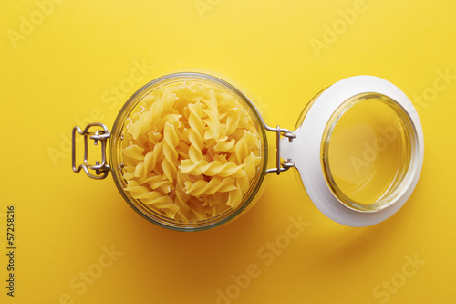 Photo: Raw fusilli pasta on a glass jar Raw fusilli pasta on a glass jar