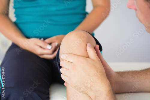 Photo: Physiotherapist checking patients knee Physiotherapist checking patients knee