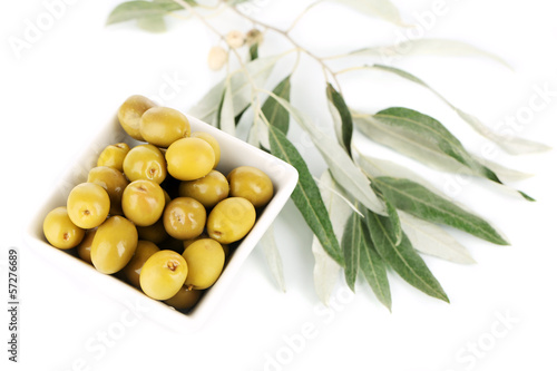 Photo: Olives in bowl with branch isolated on white Olives in bowl with branch isolated on white